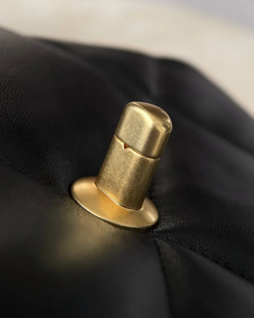 Black Quilted Mixed-Chain Flap Bag — lock detail view