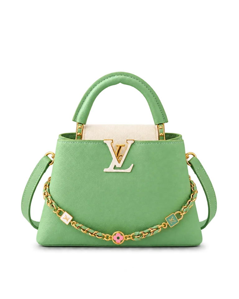Upright front view of a green and cream top-handle bag with a gold-tone charm chain and green shoulder strap