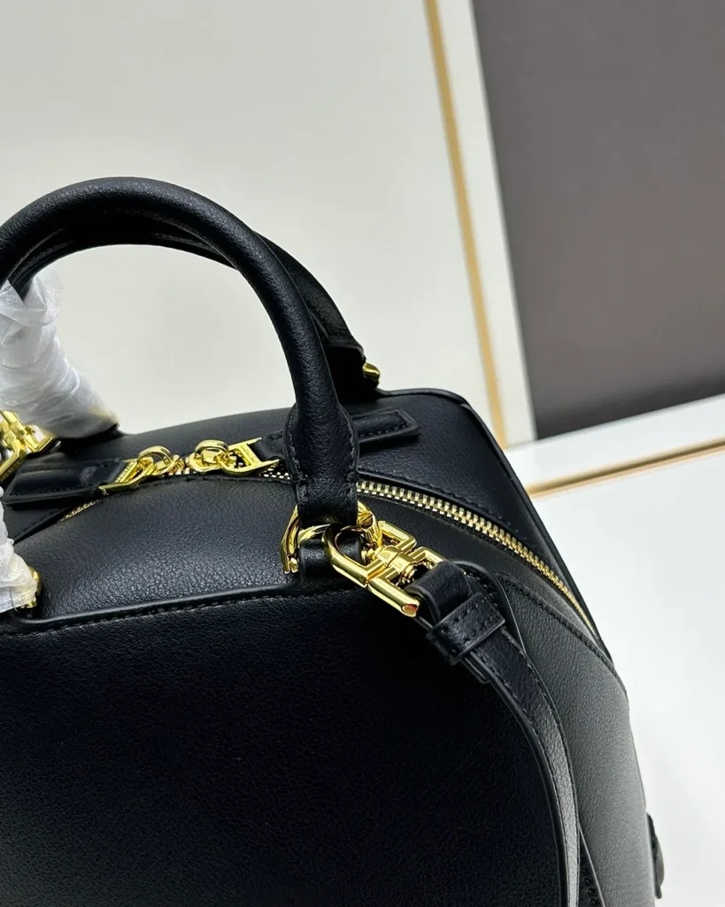 Black Domed Top Handle Bag — handle detail view