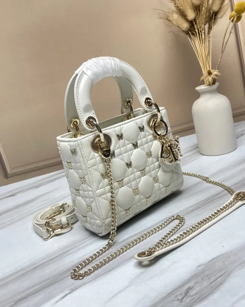 Ivory Butterfly Stud Quilted Top Handle Bag — angled front view