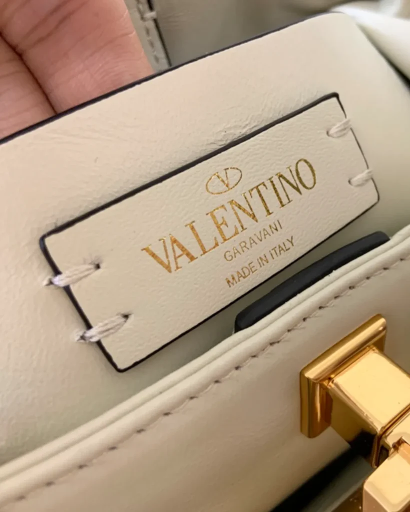 Ivory Diamond-Quilted Studded Top-Handle Bag — interior label view