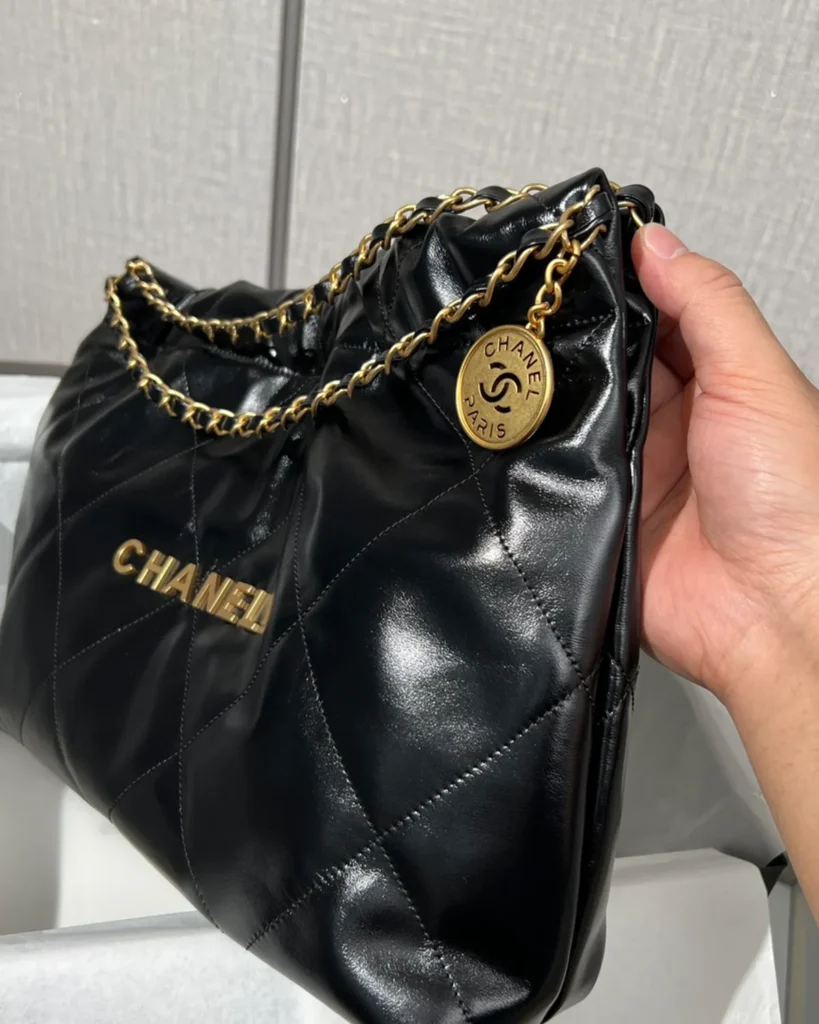 Glossy Black Quilted Chain Shopper — side view