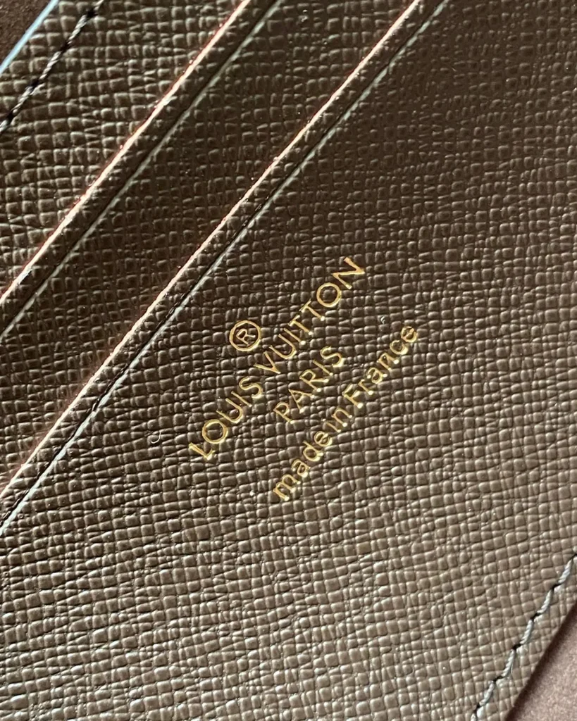 Brown Monogram Lily-Inspired Chain Wallet — interior lettering detail view