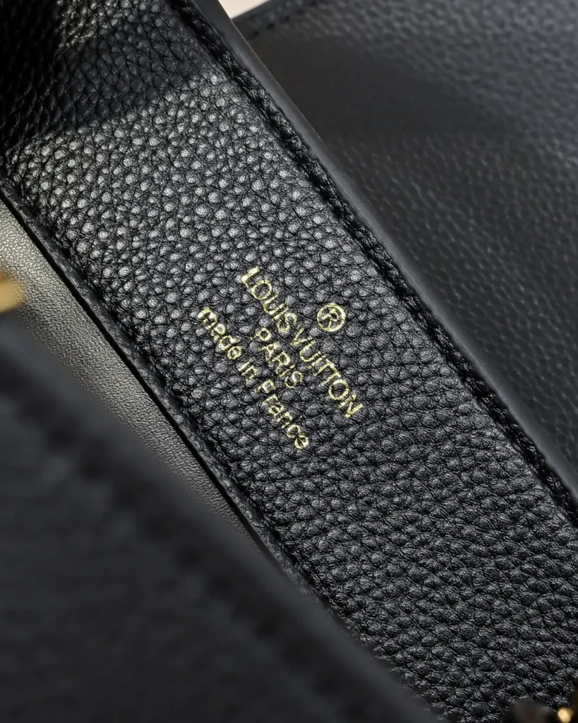 Black Floral-Chain Top-Handle Bag — interior lettering view