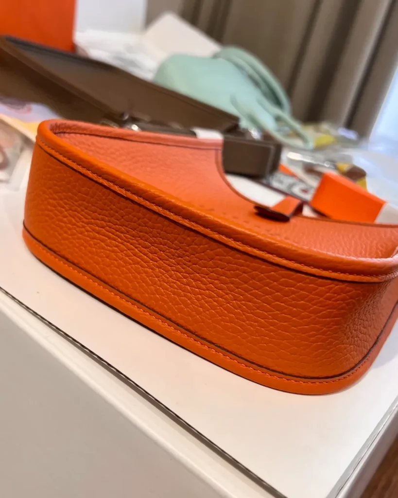Evelyne-Inspired Mini Orange Crossbody Bag, rounded base profile