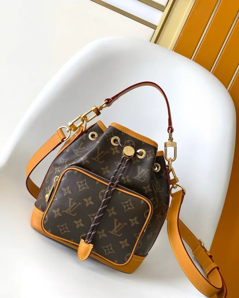 Brown Monogram Drawstring Bucket Bag with Front Pocket — angled front view