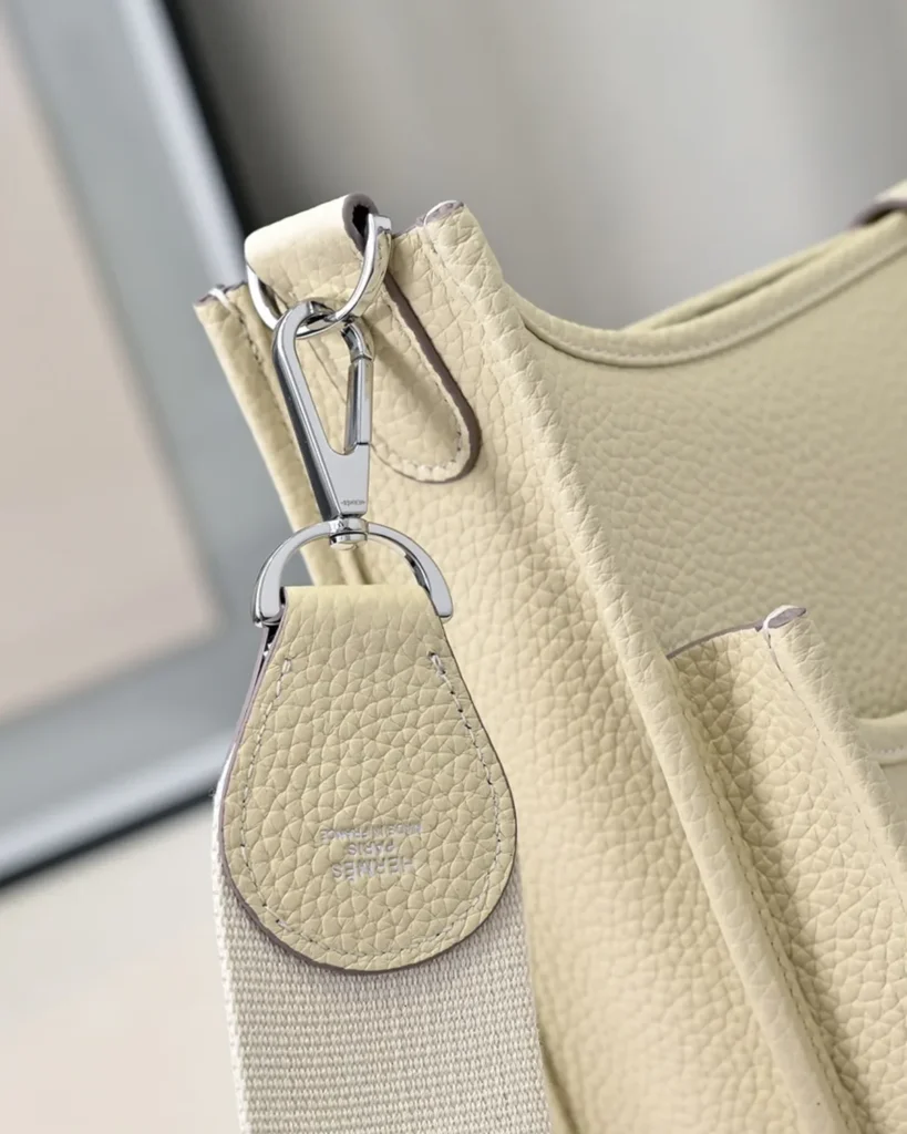Evelyne-Inspired Ivory Perforated Shoulder Bag, strap clip attachment close-up
