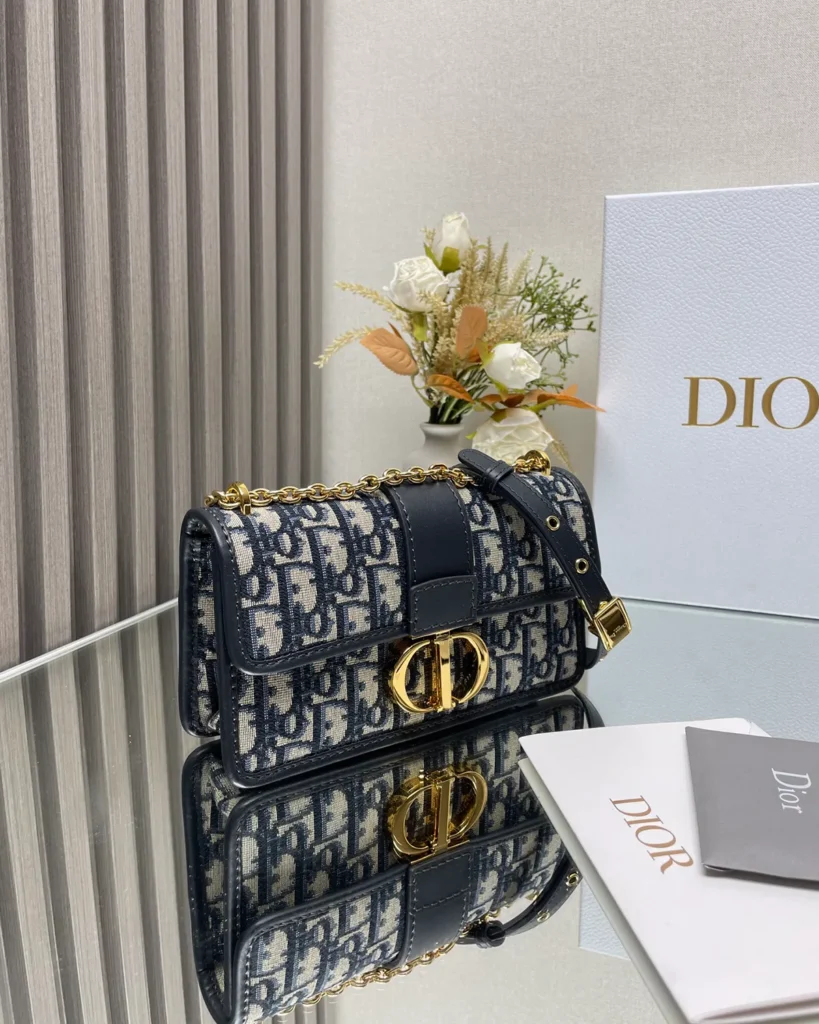 Navy Monogram Gold-Tone Chain Bag — angled front view