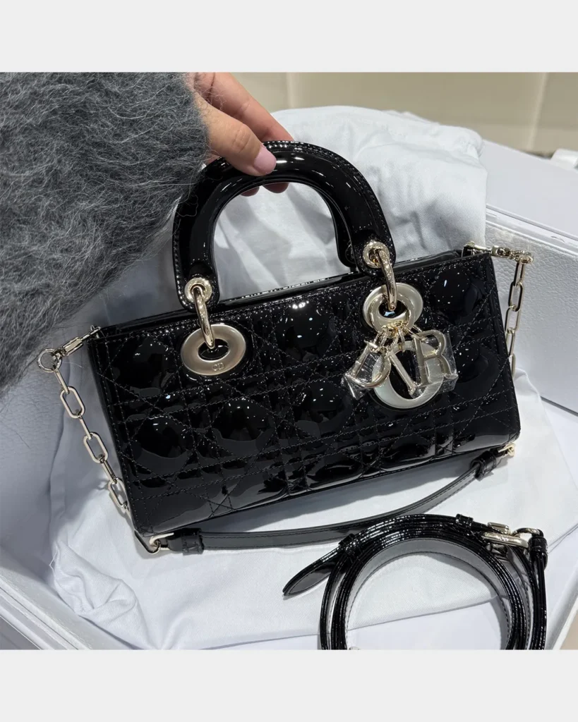 Glossy Black Horizontal Quilted Handbag — front view