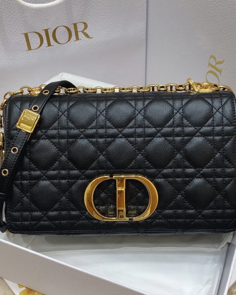 Black Quilted Flap Bag with Gold Tone Clasp — front view