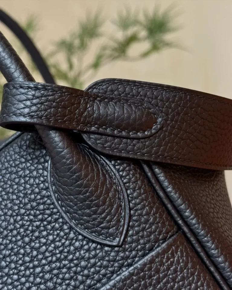 Black Folded Shoulder Bag with Gold-Tone Details — strap detail view