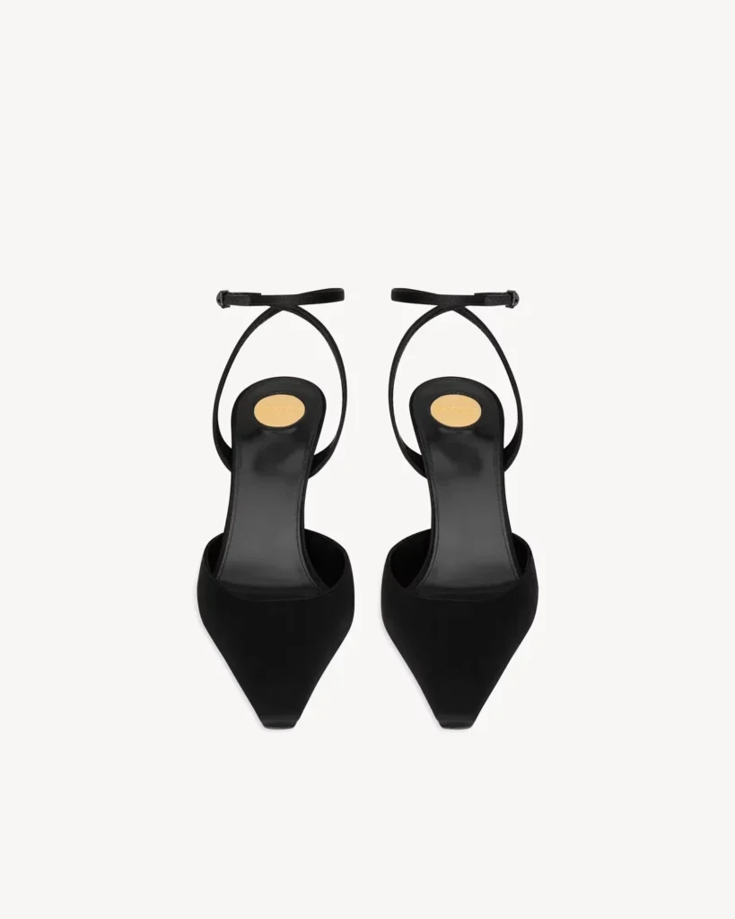 Top view of black pointed-toe slingback pumps with buckled ankle straps