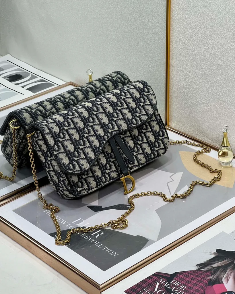Navy Monogram Asymmetric Chain Pouch — angled front view