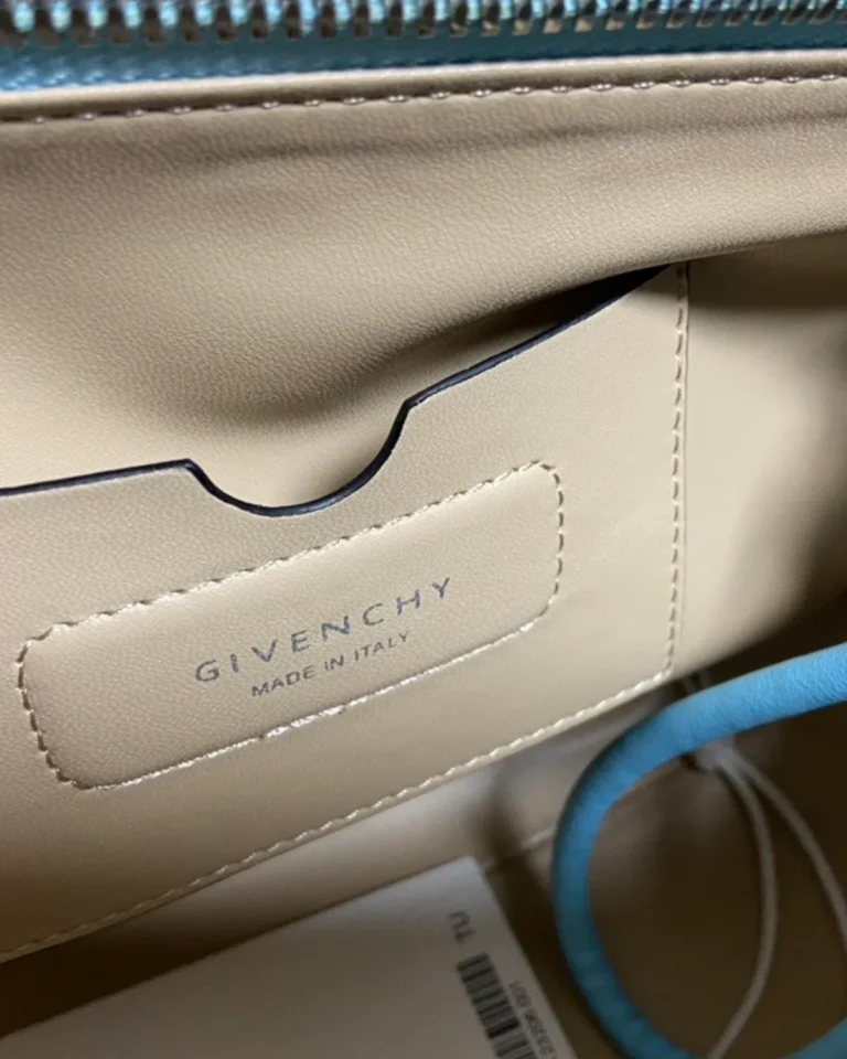 Blue Braided-Handle Flap Bag — label detail