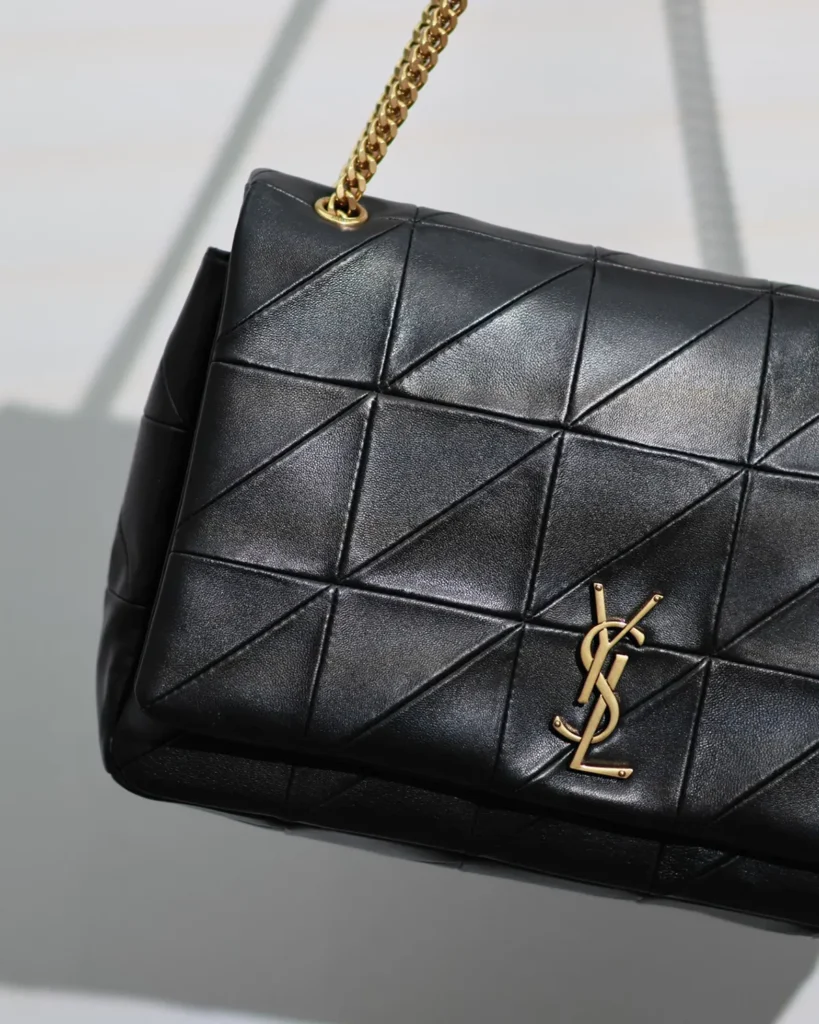 Black Geometric Quilted Flap Bag — angled front view