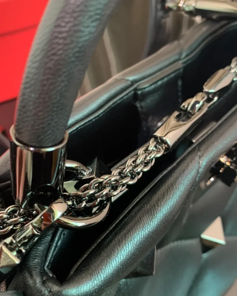 Black Diamond-Quilted Studded Top-Handle Bag — handle detail view