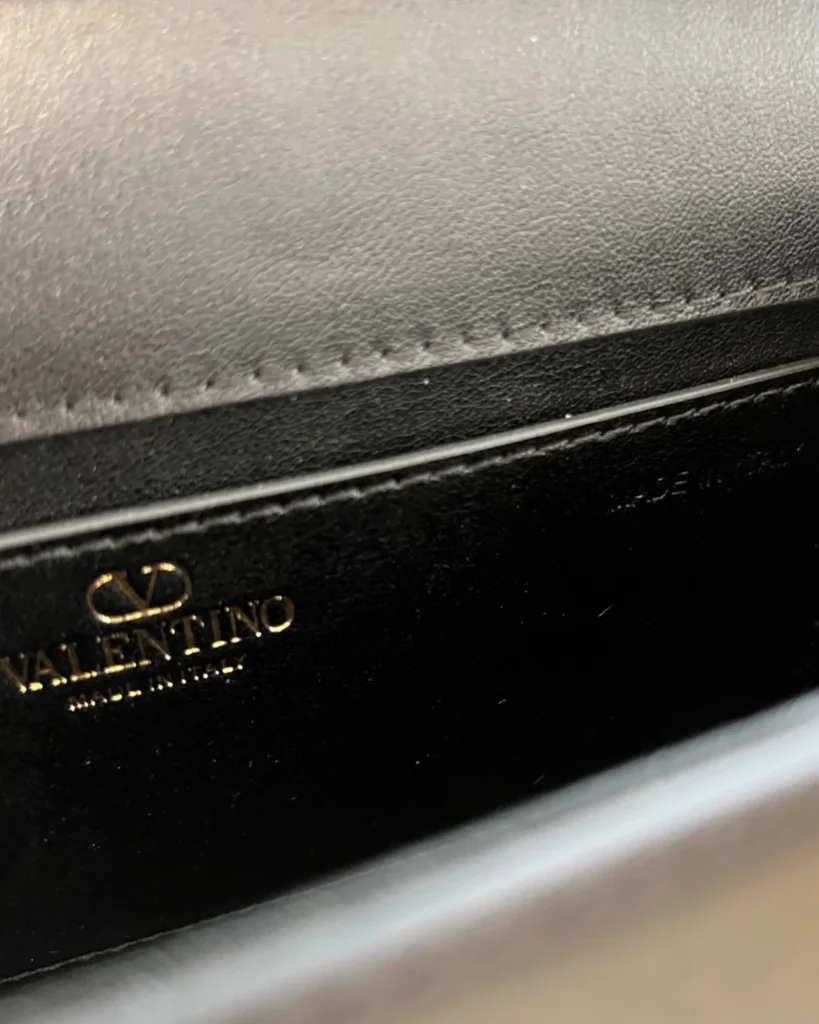 Black Stone-Detail Flap Shoulder Bag — interior lettering view