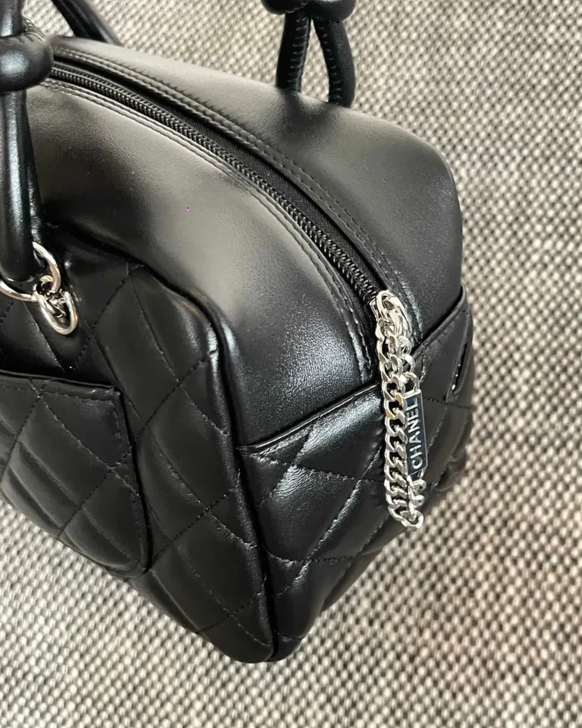 Black Quilted Offset-Emblem Bowler Bag — side view