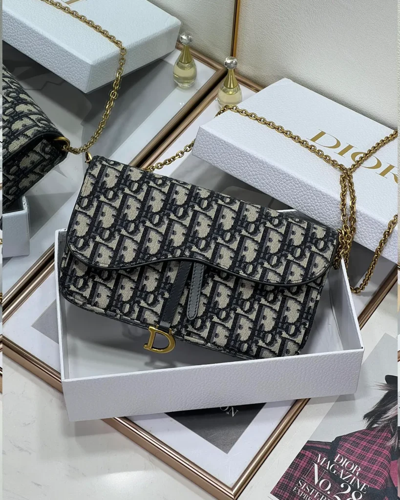 Navy Monogram Asymmetric Chain Pouch — boxed front view
