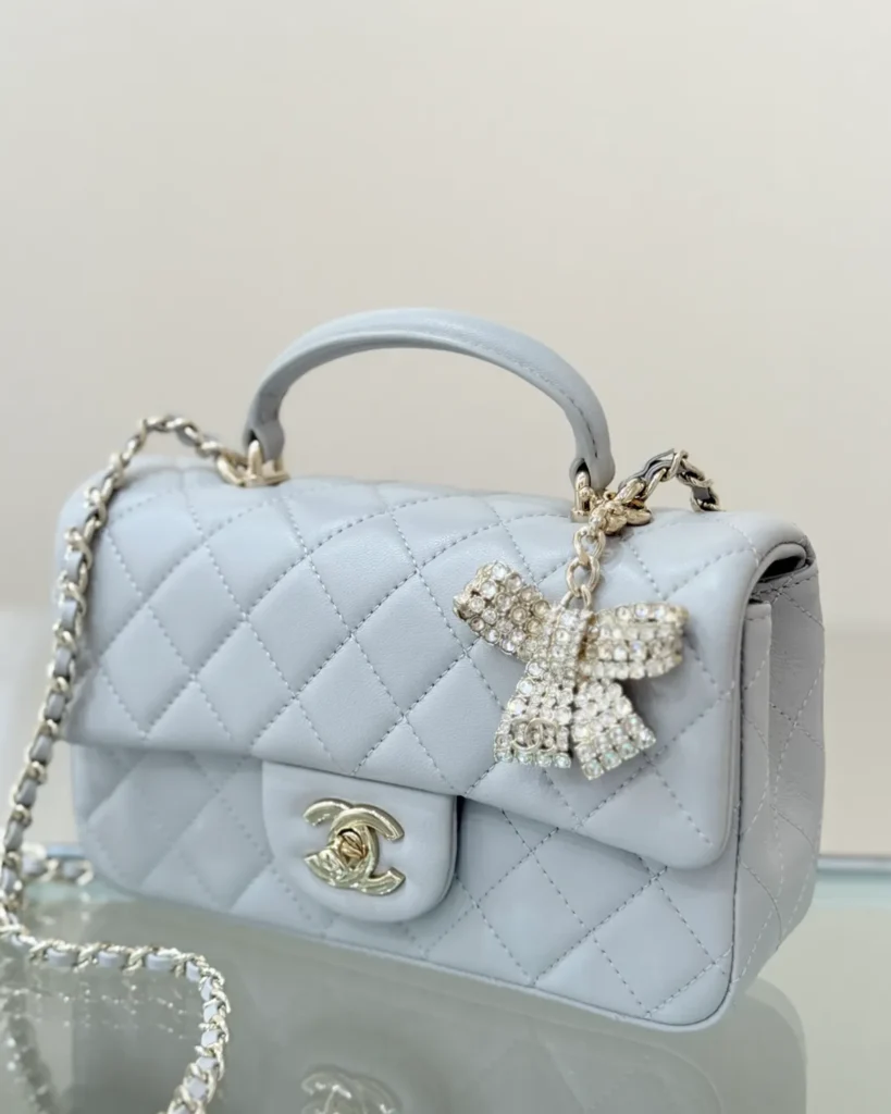 Pale Grey Quilted Top-Handle Flap Bag — bow accessory view