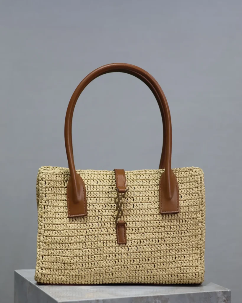 Natural-Tone Woven Tote with Brown Handles — front on plinth view