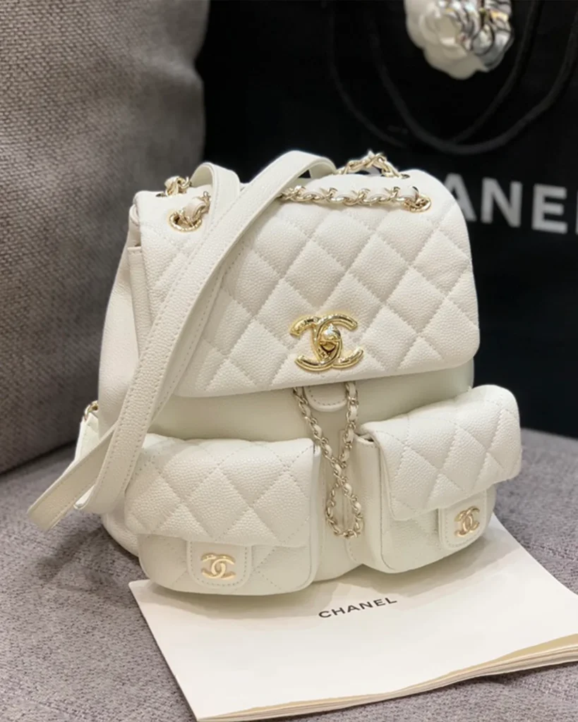 Ivory Quilted Twin-Pocket Backpack — angled front view
