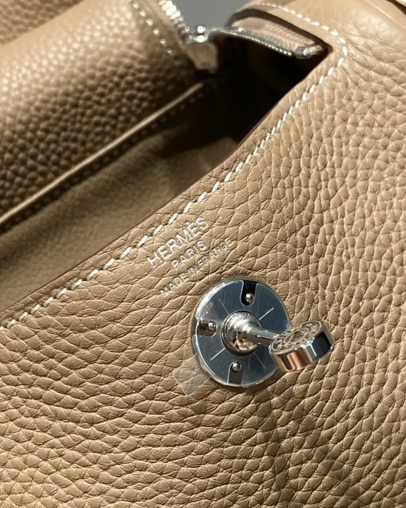 Lindy-Inspired Mini Taupe Crossbody Bag, turn-lock and contrast stitching close-up