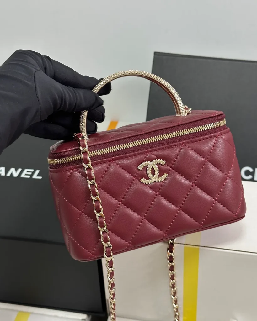 Burgundy Quilted Ornamental-Handle Vanity Bag — held front view