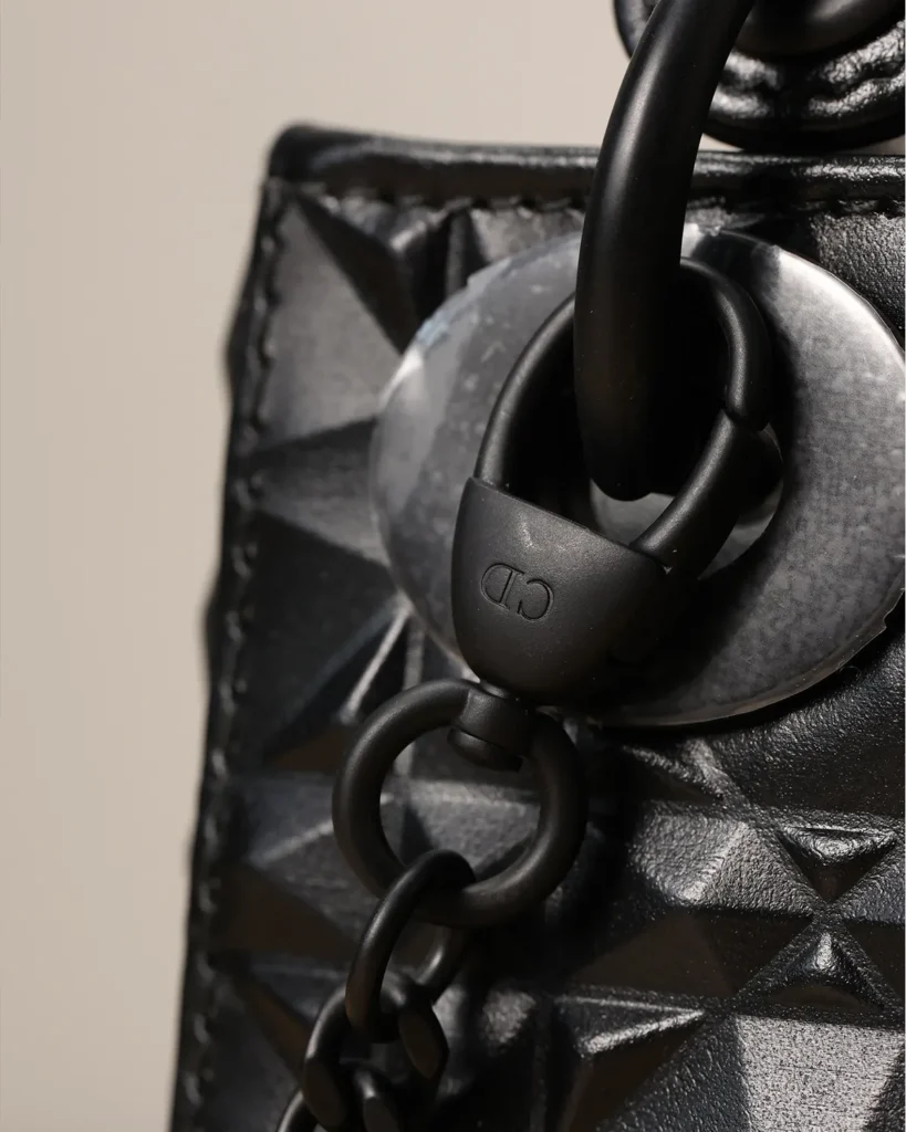 Black Faceted Top Handle Bag — hardware detail view