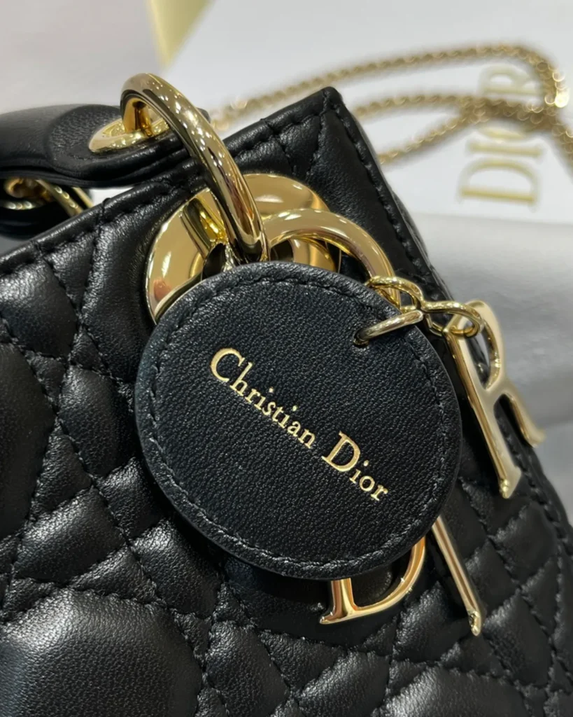 Black Quilted Chain Top Handle Bag — tag detail view