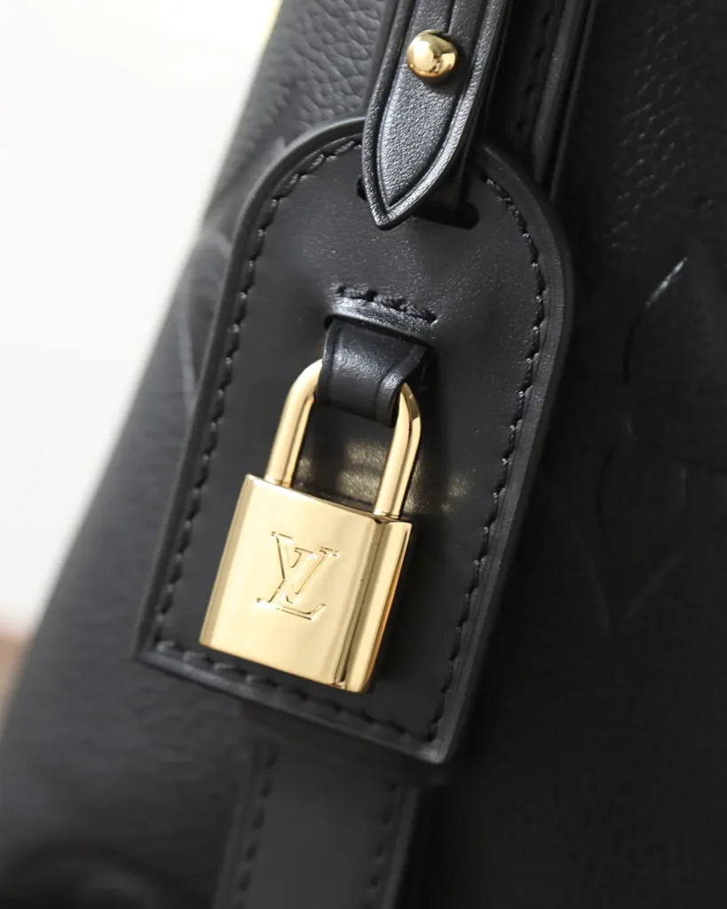 Black Embossed Monogram Bucket Bag — padlock view