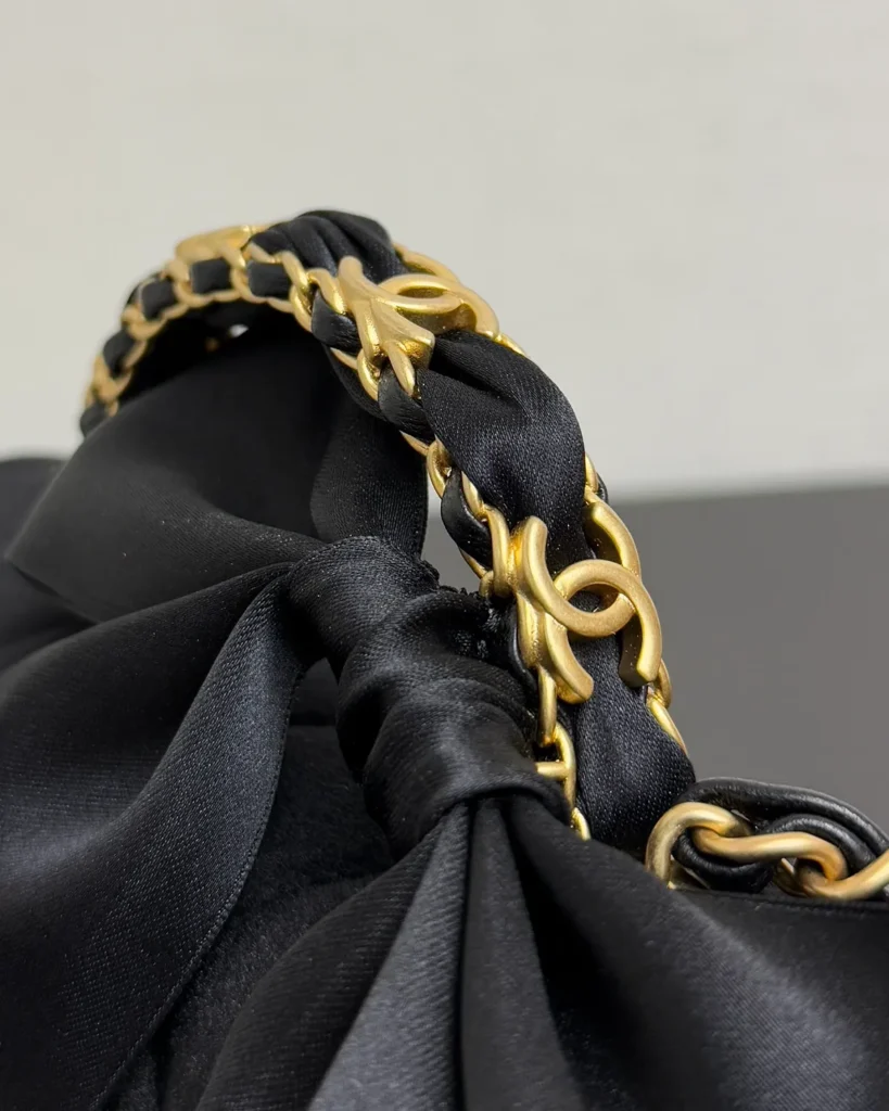 Black Bow-Detail Quilted Top-Handle Bag — handle detail view