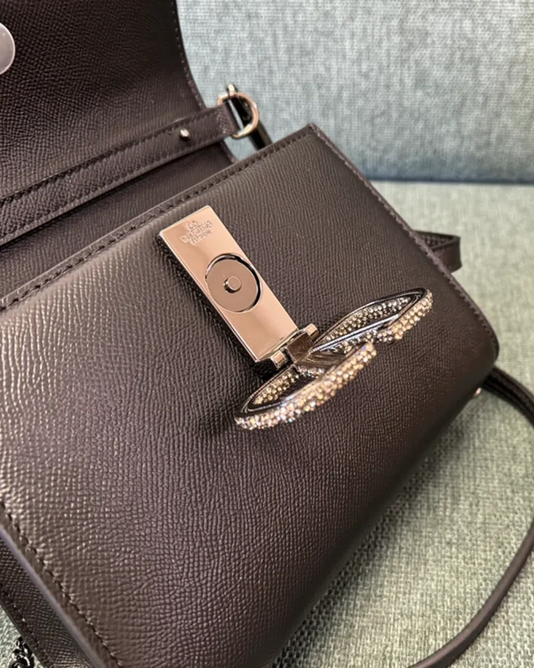 Dark Brown Embellished Emblem Top-Handle Bag — closure detail view