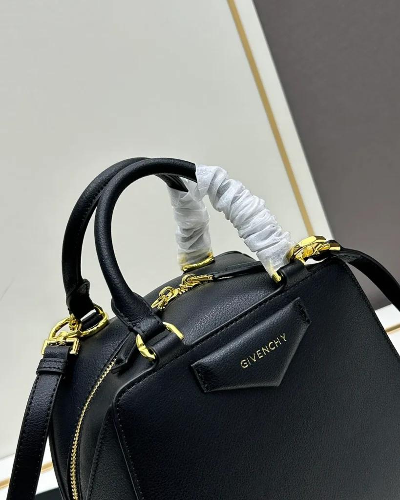 Black Domed Top Handle Bag — logo detail view
