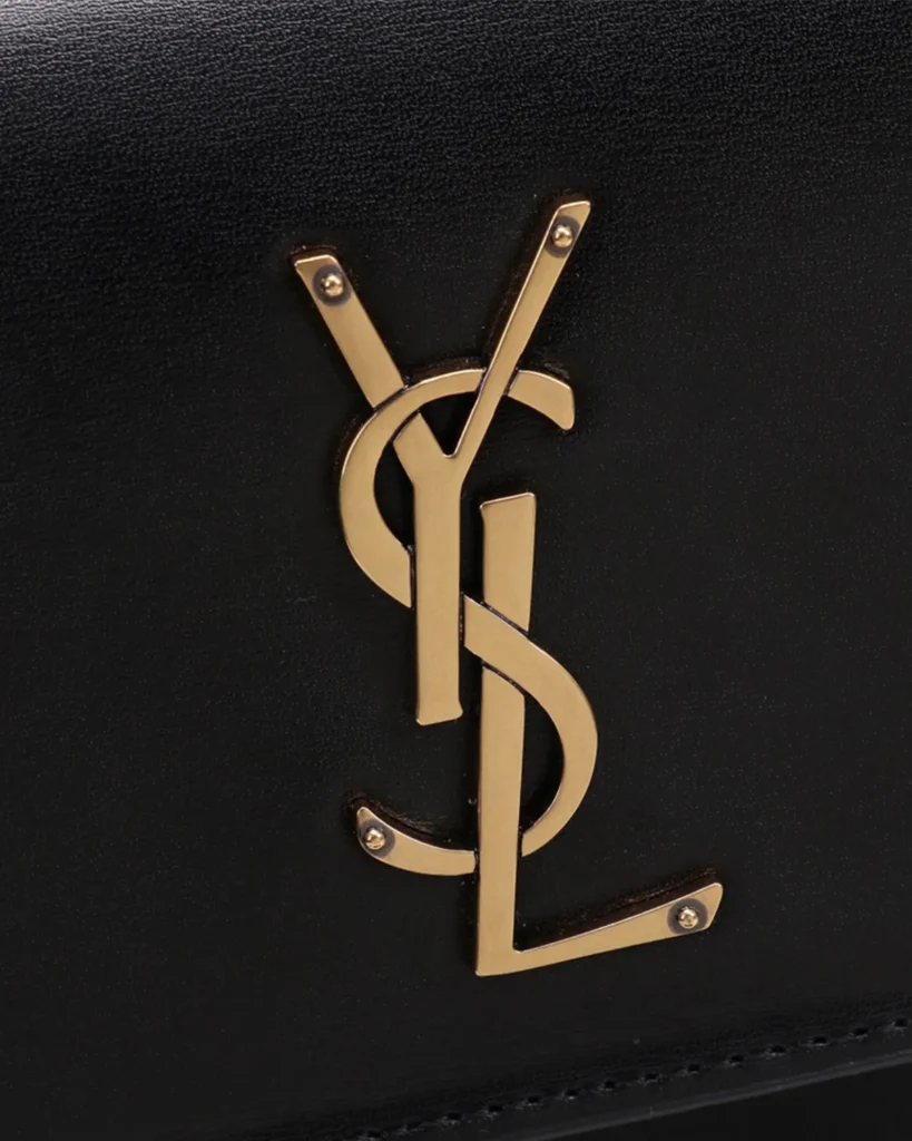 Black Accordion Chain Flap Bag — logo detail view