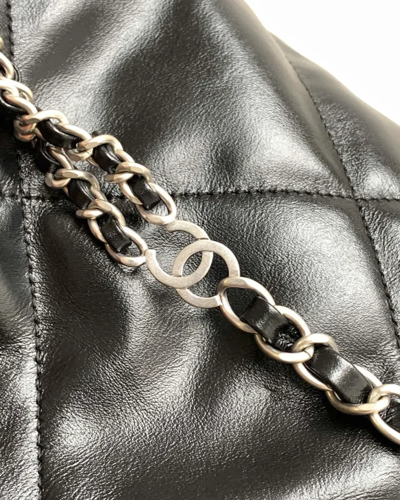 Glossy Black Quilted Gathered Tote — chain detail view