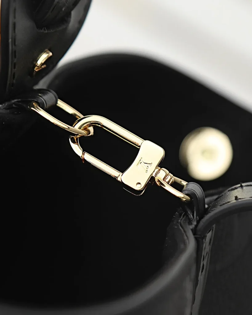 Black Embossed Monogram Bucket Bag — strap clip view