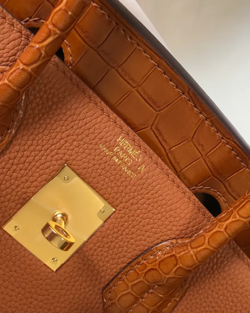 Birkin-Inspired 25 Gold Tan Mixed-Texture Tote, front lock and scale-patterned trim close-up