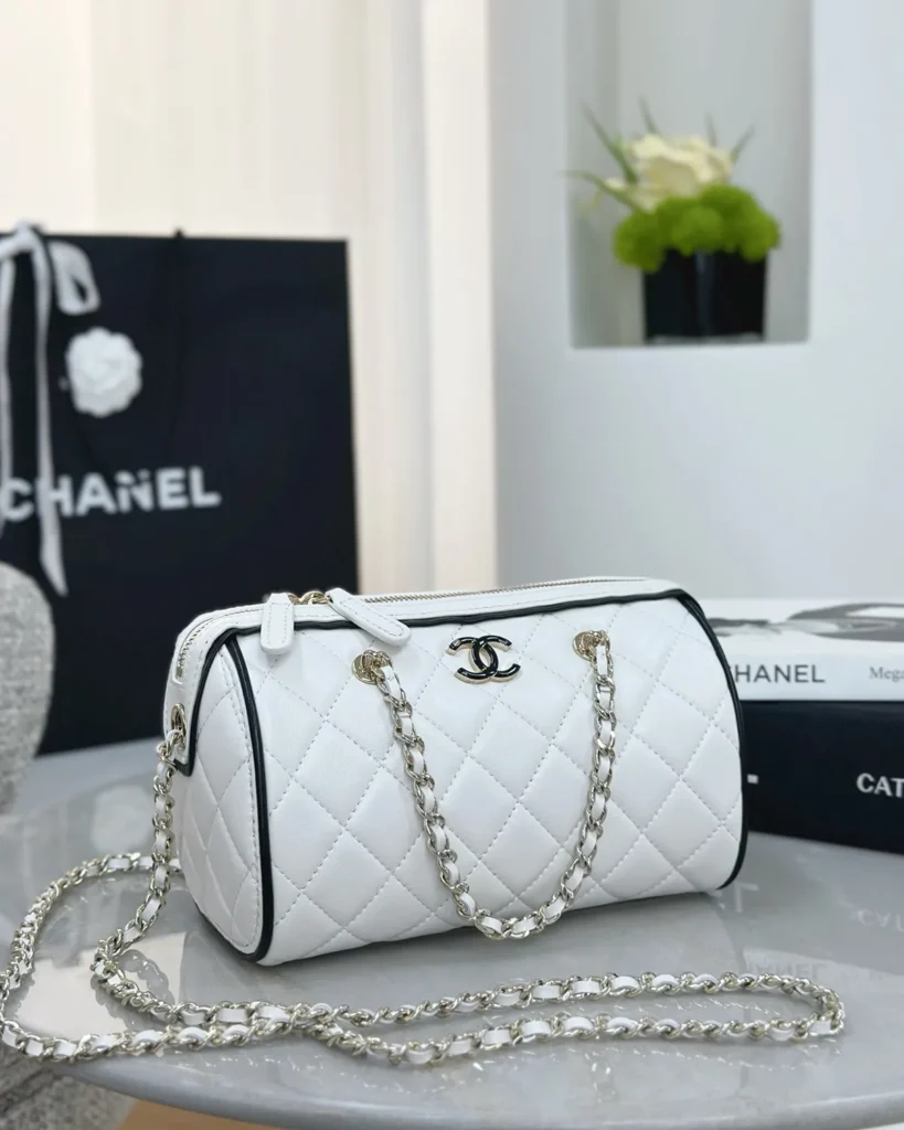 White and Black Quilted Chain Bowler Bag — angled front view