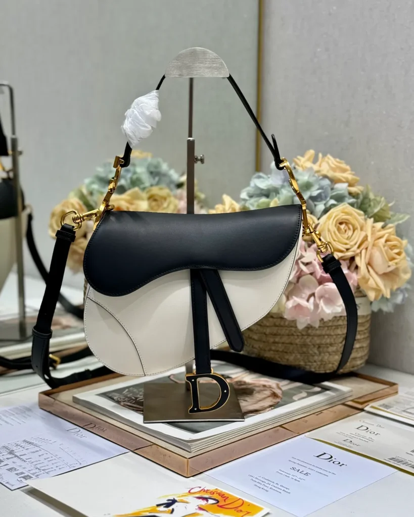 Cream and Black Asymmetric Saddle Bag — front view
