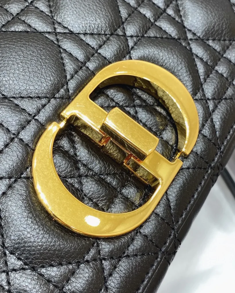 Black Quilted Flap Bag with Gold Tone Clasp — clasp view