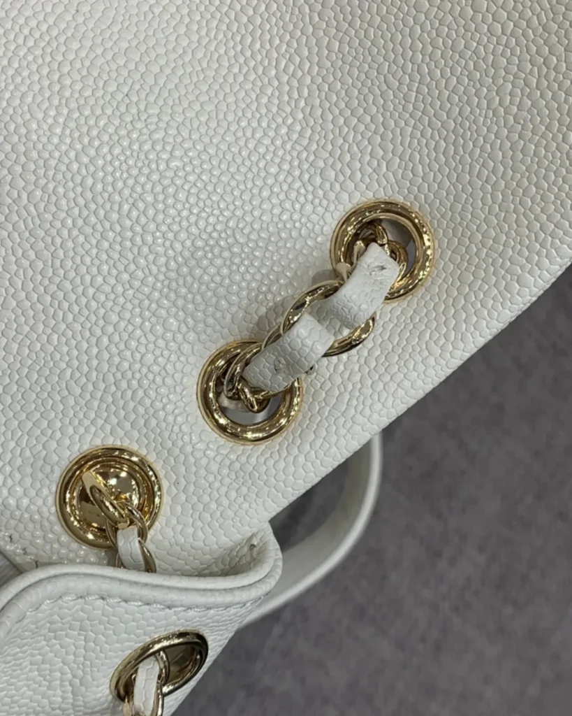 Ivory Quilted Twin-Pocket Backpack — chain detail view