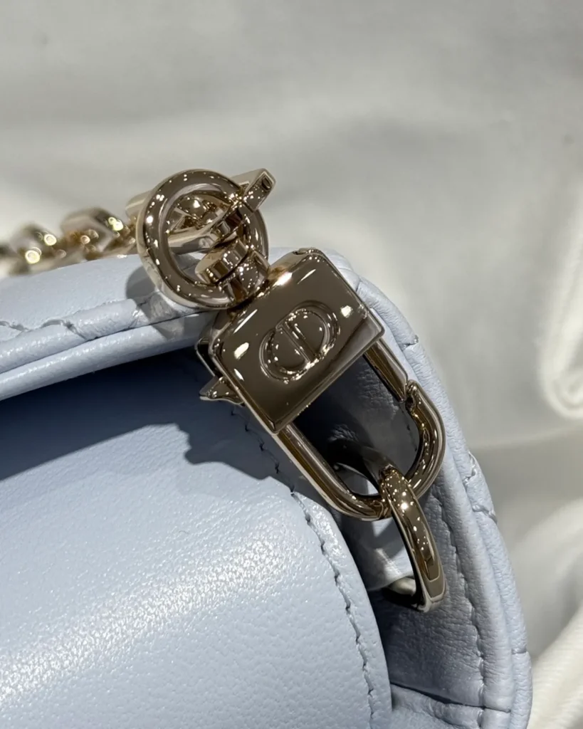 Pale Blue Horizontal Quilted Top Handle Bag — clip detail view