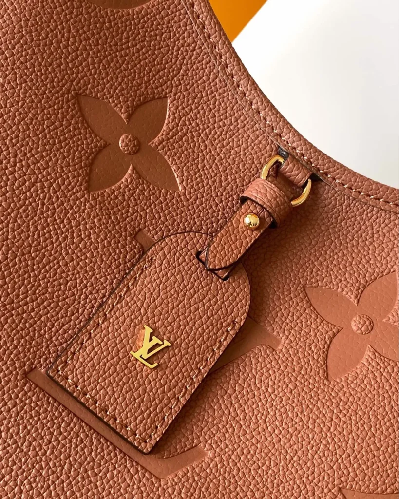 Cognac Embossed Monogram Shoulder Bag — tag view