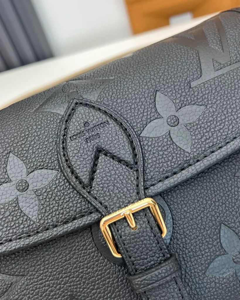Black Embossed-Monogram Buckle Satchel — buckle detail view