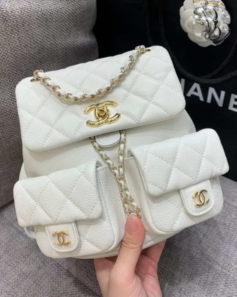 Ivory Quilted Twin-Pocket Backpack — held front view