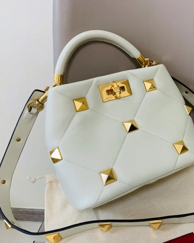 Ivory Diamond-Quilted Studded Top-Handle Bag — angled front view