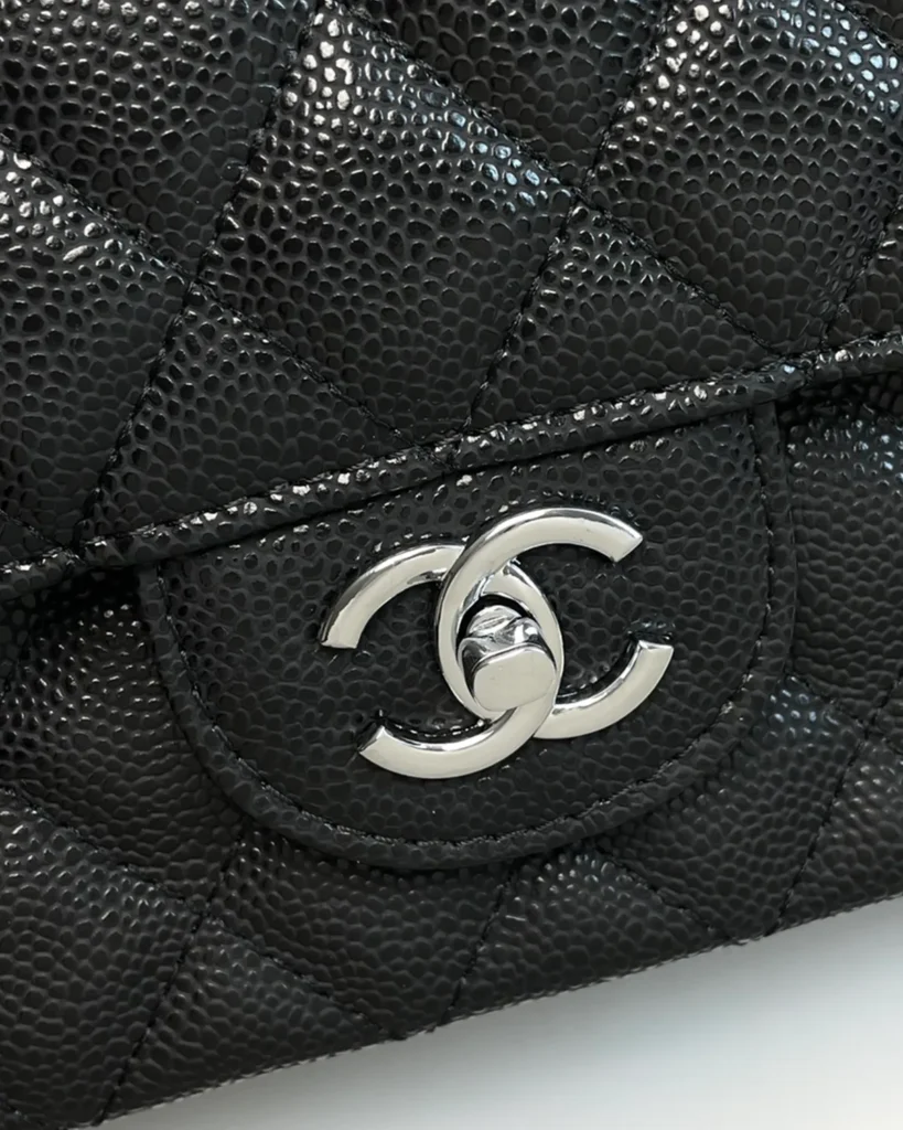 Black Quilted Silver-Tone Chain Flap Bag — logo detail view
