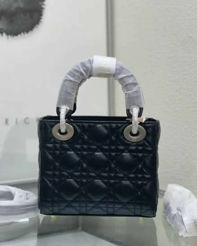 Black Quilted Top Handle Bag with Silver-Tone Charms — rear view