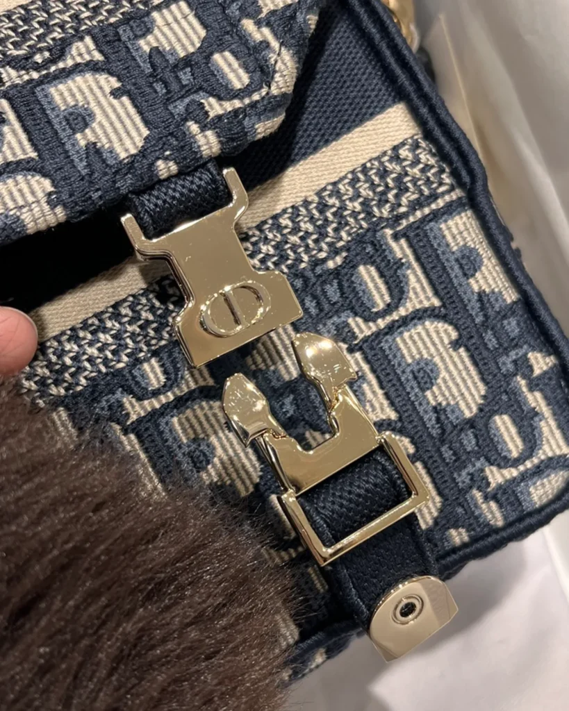 Navy Monogram Twin-Clasp Messenger Bag — clasp detail view